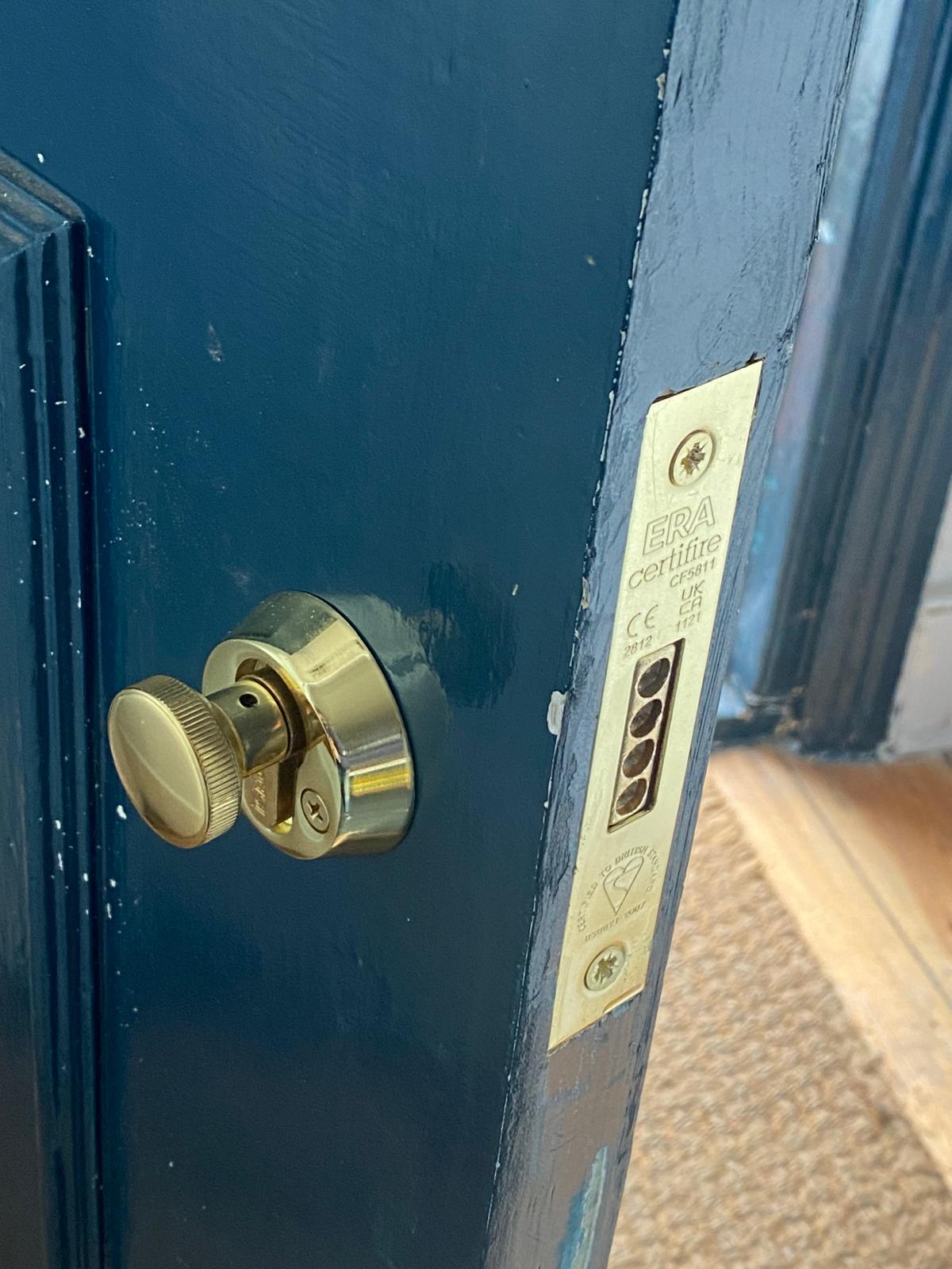 High-security mortice lock and lever handles on a wooden door